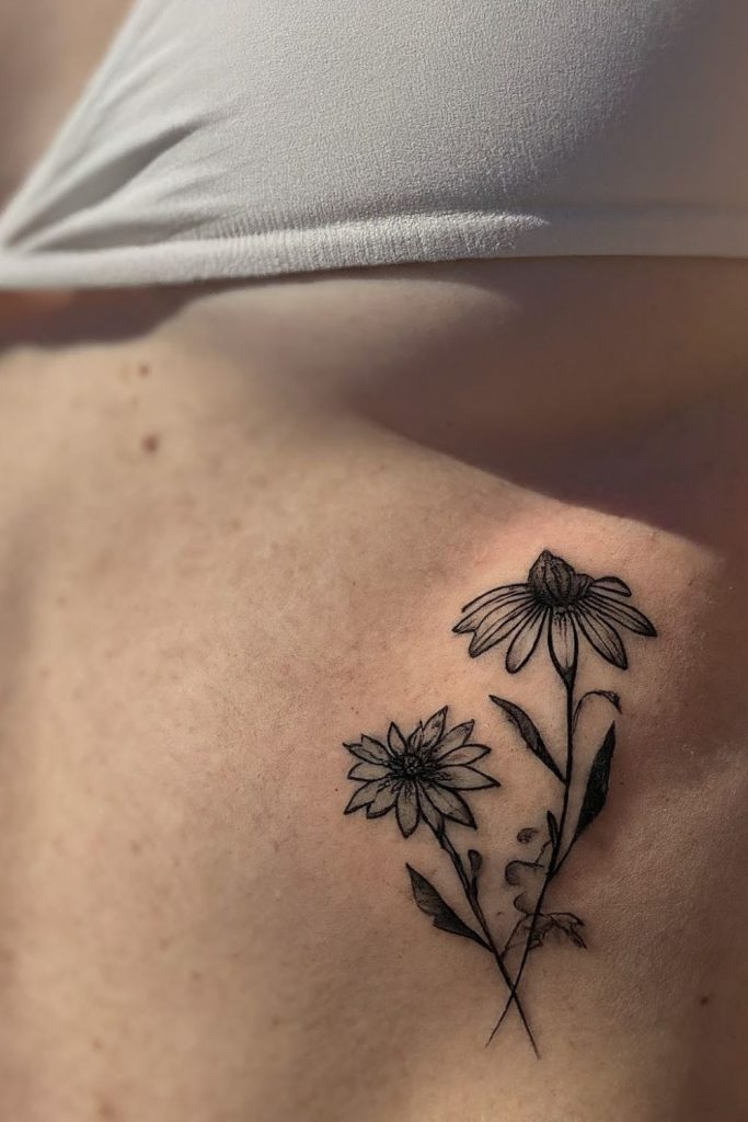 blackwork coneflower tattoo