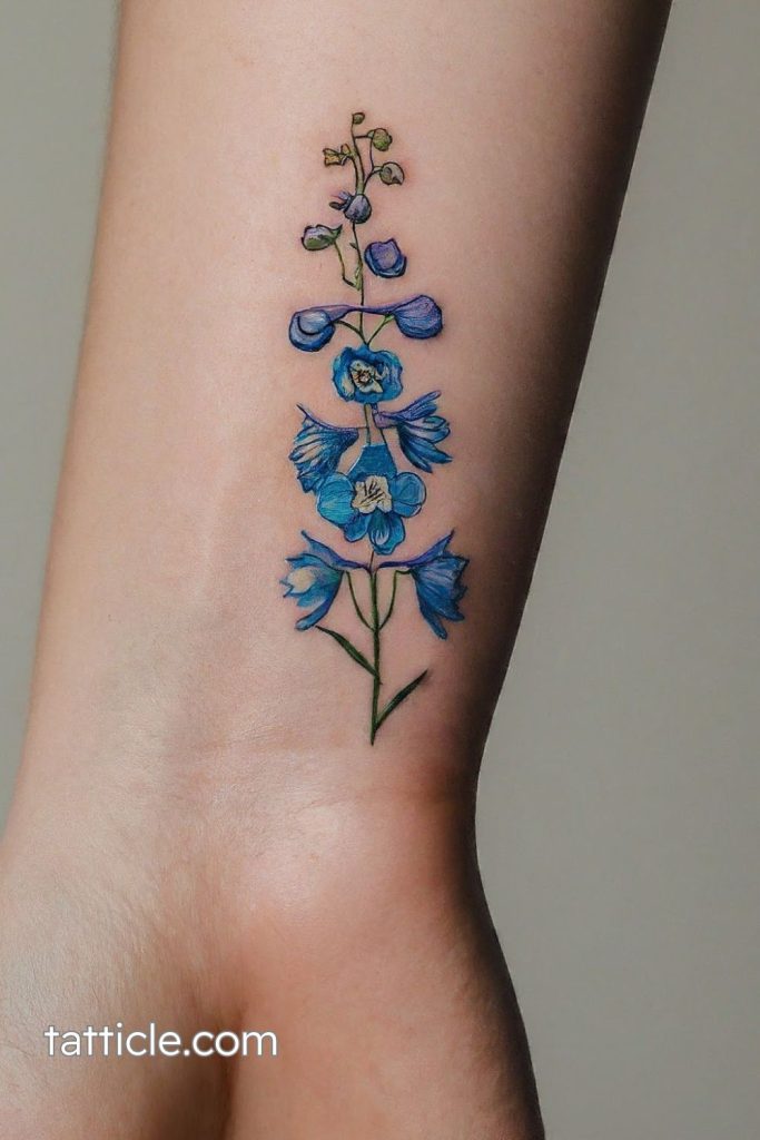 small delphinium tattoo wrist